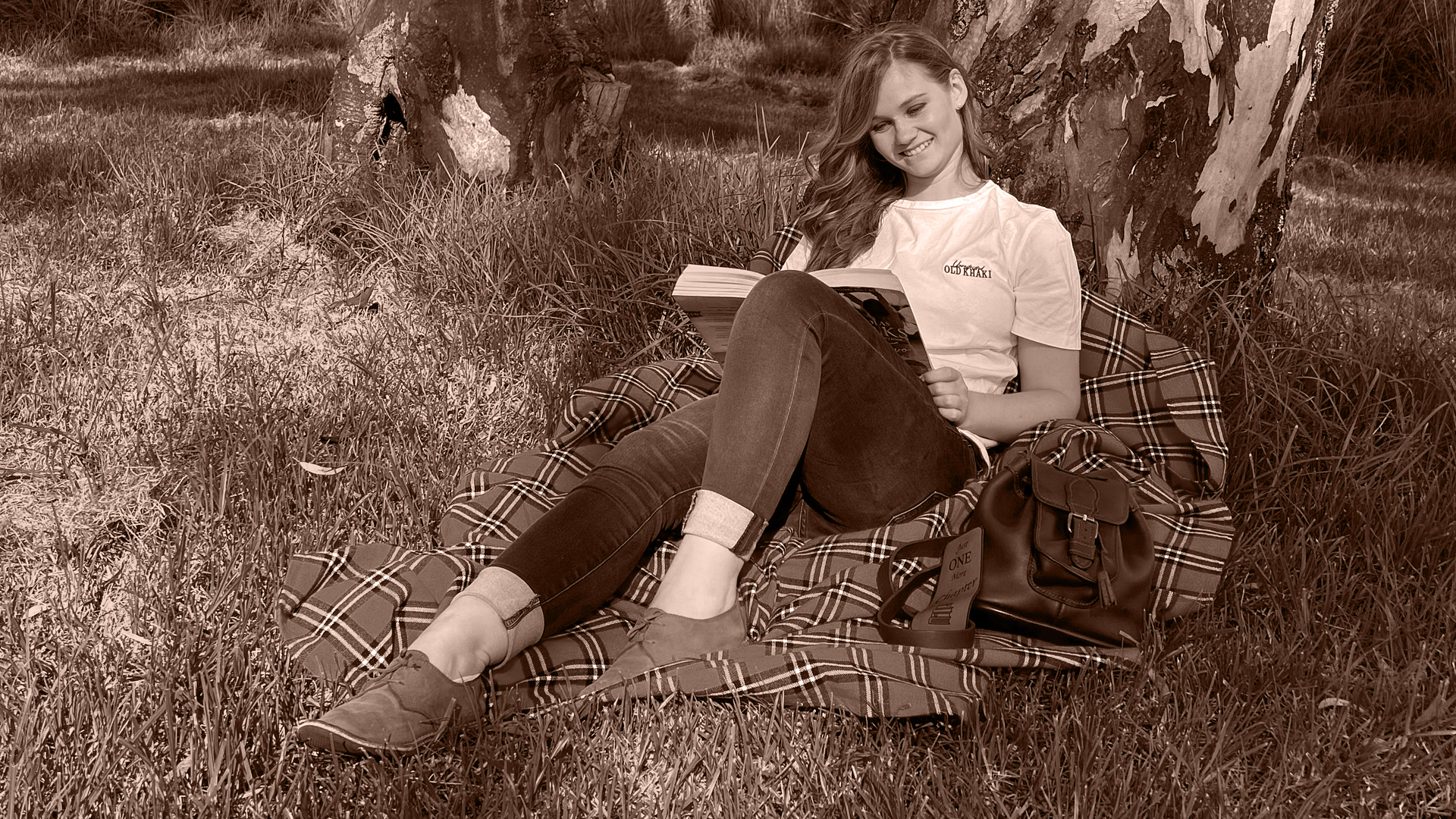 Altia reading under a tree