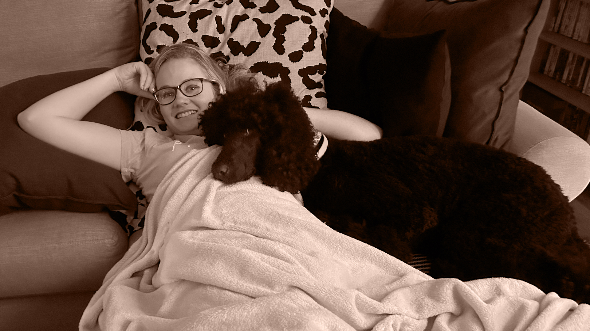 Altia on the couch with a dog watching tv