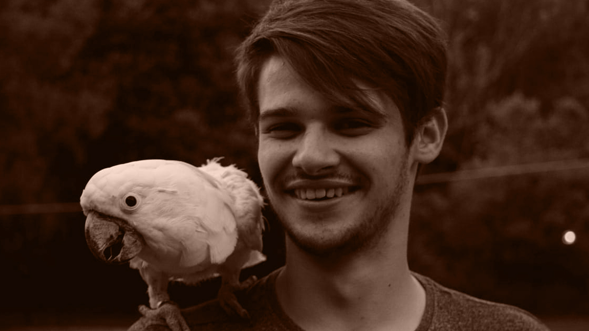 Lanzo with a White cockatoo on his shoulder